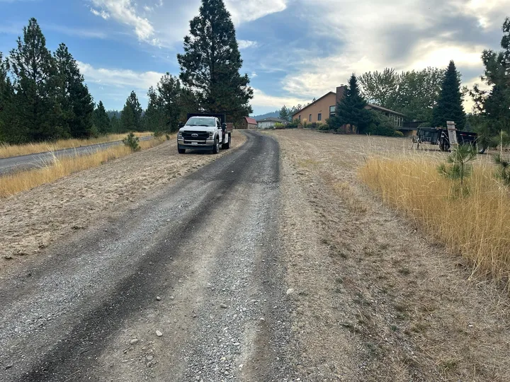 New gravel driveway curving through ponderosa pines